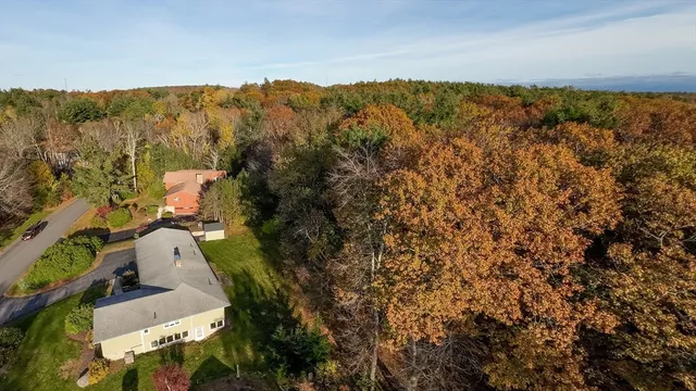 an aerial view of a house with a yard
