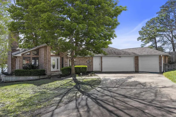 a house that has a tree in front of it