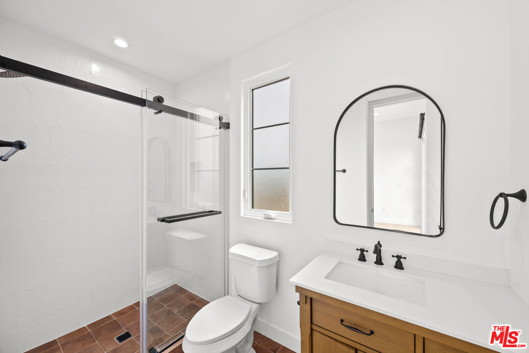 2324 South Dunsmuir Avenue, Unit 1/2 Los Angeles, CA 90016 - Photo 12 of 27 a bathroom with a sink toilet and shower