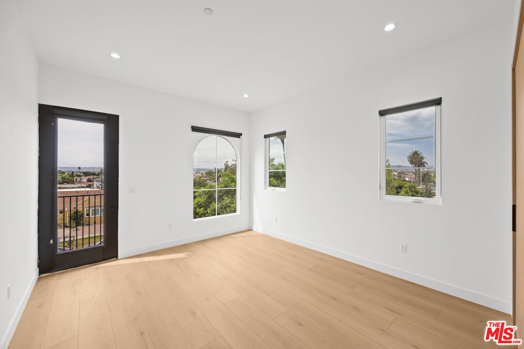 2324 South Dunsmuir Avenue, Unit 1/2 Los Angeles, CA 90016 - Photo 14 of 27 an empty room with windows and closet