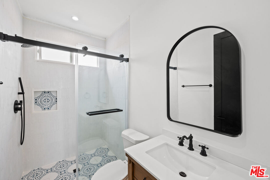 2324 South Dunsmuir Avenue, Unit 1/2 Los Angeles, CA 90016 - Photo 16 of 27 a bathroom with a sink and mirror