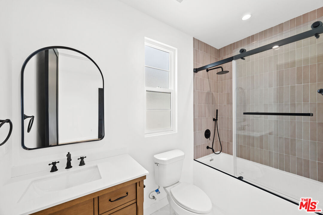 2324 South Dunsmuir Avenue, Unit 1/2 Los Angeles, CA 90016 - Photo 18 of 27 a bathroom with a sink toilet and shower