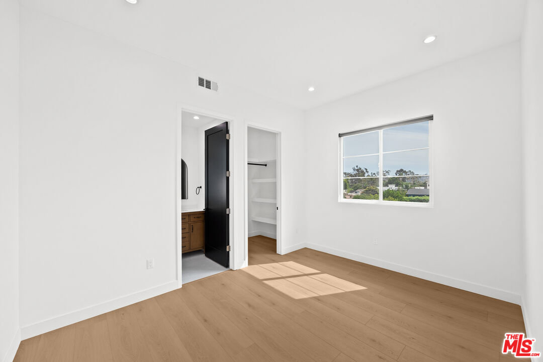 2324 South Dunsmuir Avenue, Unit 1/2 Los Angeles, CA 90016 - Photo 20 of 27 a view of an empty room with closet and a window