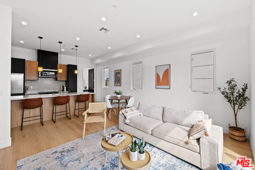 2324 South Dunsmuir Avenue, Unit 1/2 Los Angeles, CA 90016 - Photo 2 of 27 a living room with furniture kitchen view and a table