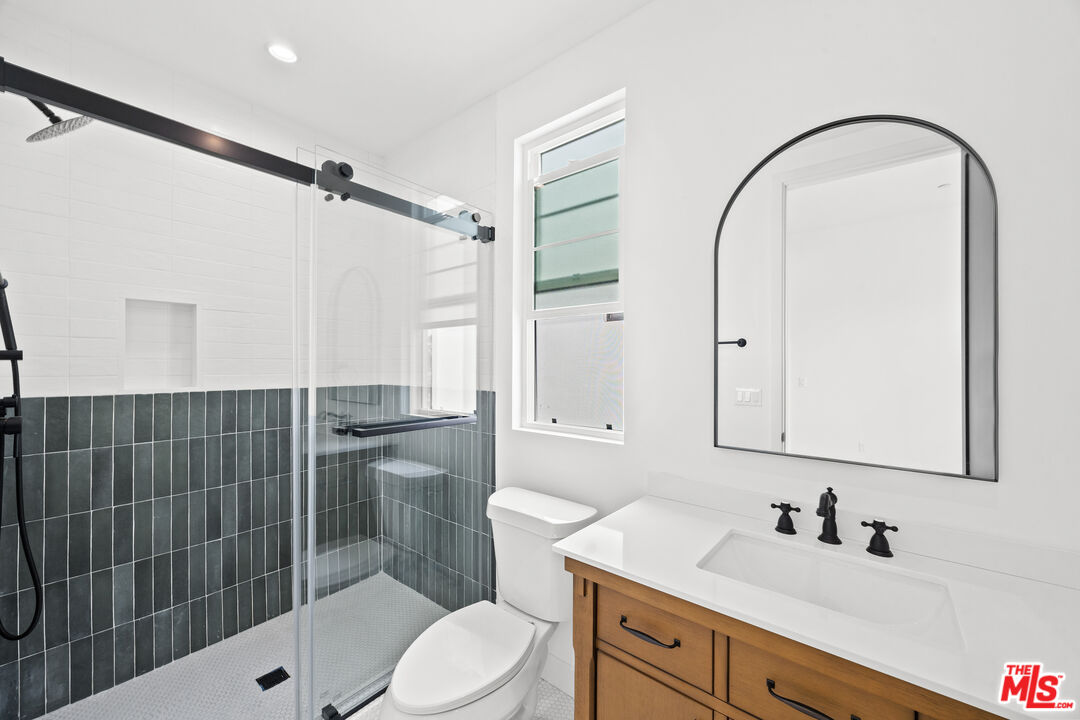 2324 South Dunsmuir Avenue, Unit 1/2 Los Angeles, CA 90016 - Photo 21 of 27 a bathroom with a sink a toilet and shower