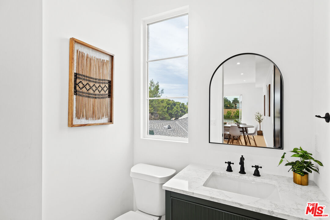 2324 South Dunsmuir Avenue, Unit 1/2 Los Angeles, CA 90016 - Photo 22 of 27 a bathroom with a sink and a mirror