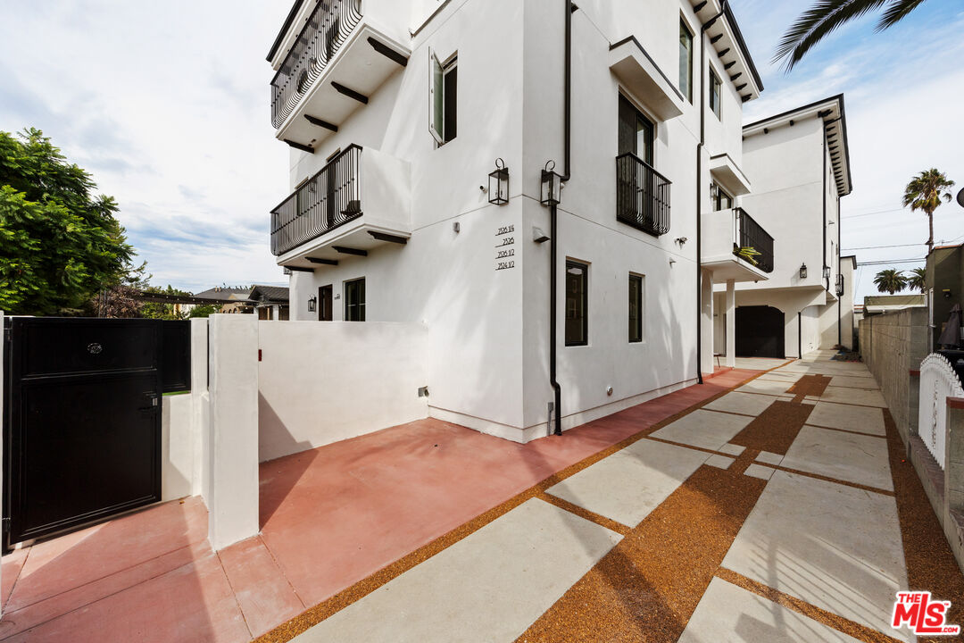 2324 South Dunsmuir Avenue, Unit 1/2 Los Angeles, CA 90016 - Photo 25 of 27 a view of a white building with many windows
