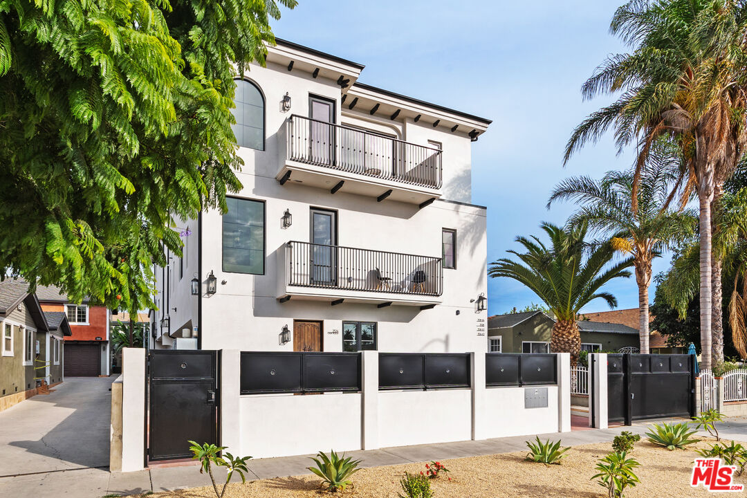 2324 South Dunsmuir Avenue, Unit 1/2 Los Angeles, CA 90016 - Photo 26 of 27 a front view of multiple houses with yard