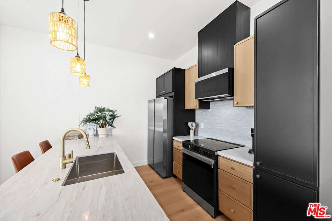 2324 South Dunsmuir Avenue, Unit 1/2 Los Angeles, CA 90016 - Photo 5 of 27 a kitchen with a sink appliances and cabinets