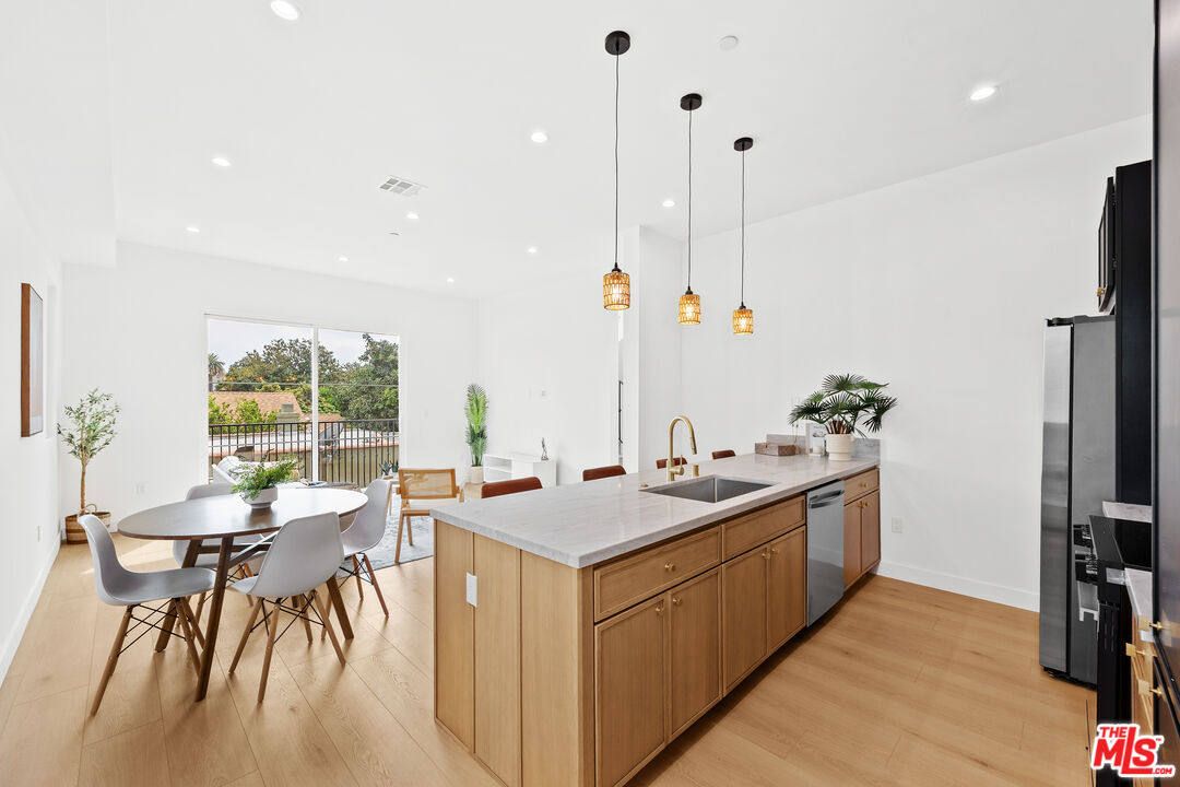 2324 South Dunsmuir Avenue, Unit 1/2 Los Angeles, CA 90016 - Photo 6 of 27 a kitchen with stainless steel appliances granite countertop a sink and a stove