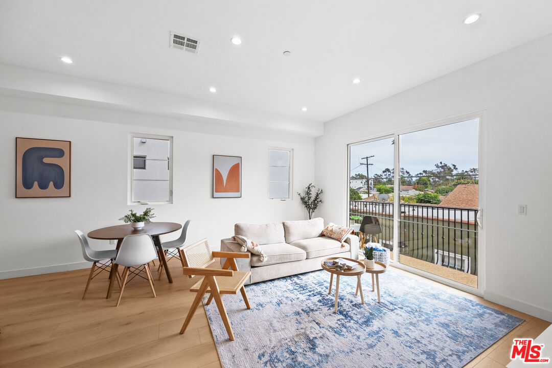 2324 South Dunsmuir Avenue, Unit 1/2 Los Angeles, CA 90016 - Photo 7 of 27 a living room with furniture and a wooden floor