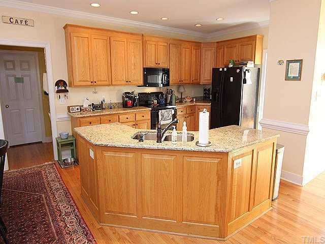 2716 Amstel Way Raleigh, NC 27613 - Photo 4 of 12 a kitchen with stainless steel appliances granite countertop a refrigerator and a stove