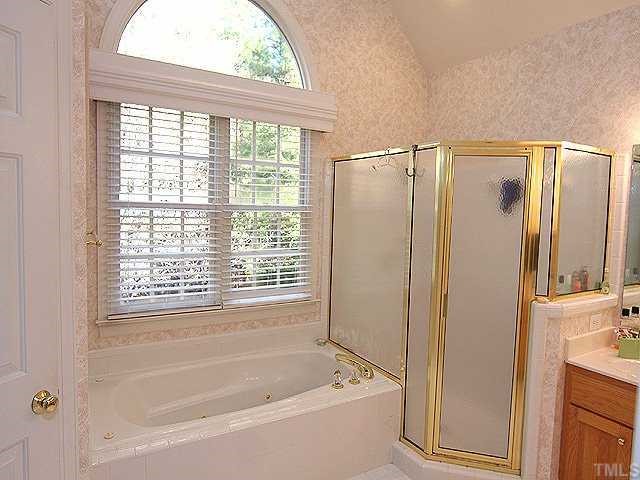 2716 Amstel Way Raleigh, NC 27613 - Photo 9 of 12 a bathroom with a bathtub and a shower