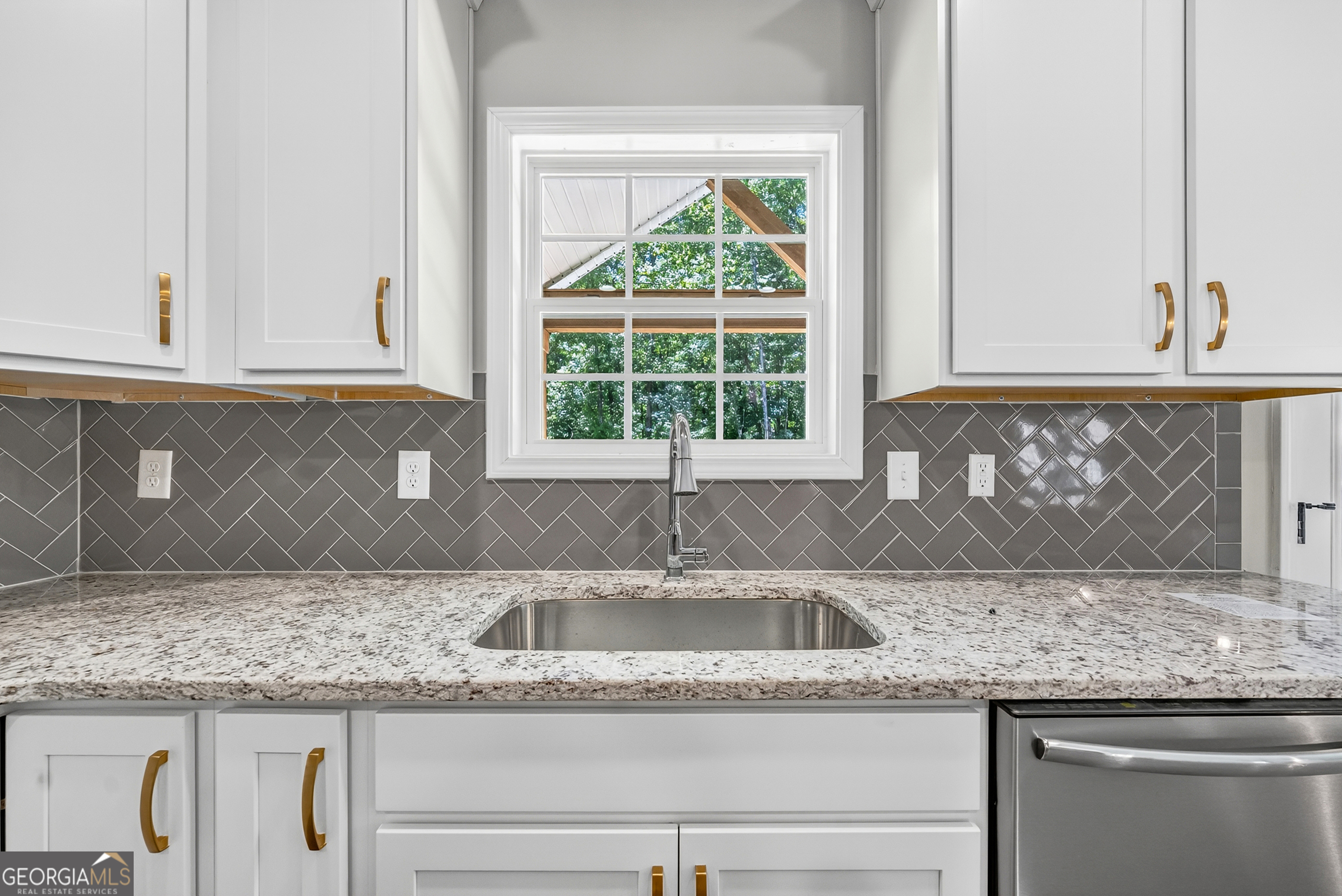 38 Oak Ridge Drive, Unit 26 Waverly Hall, GA 31831 - Photo 16 of 37 a kitchen with granite countertop a sink and a window
