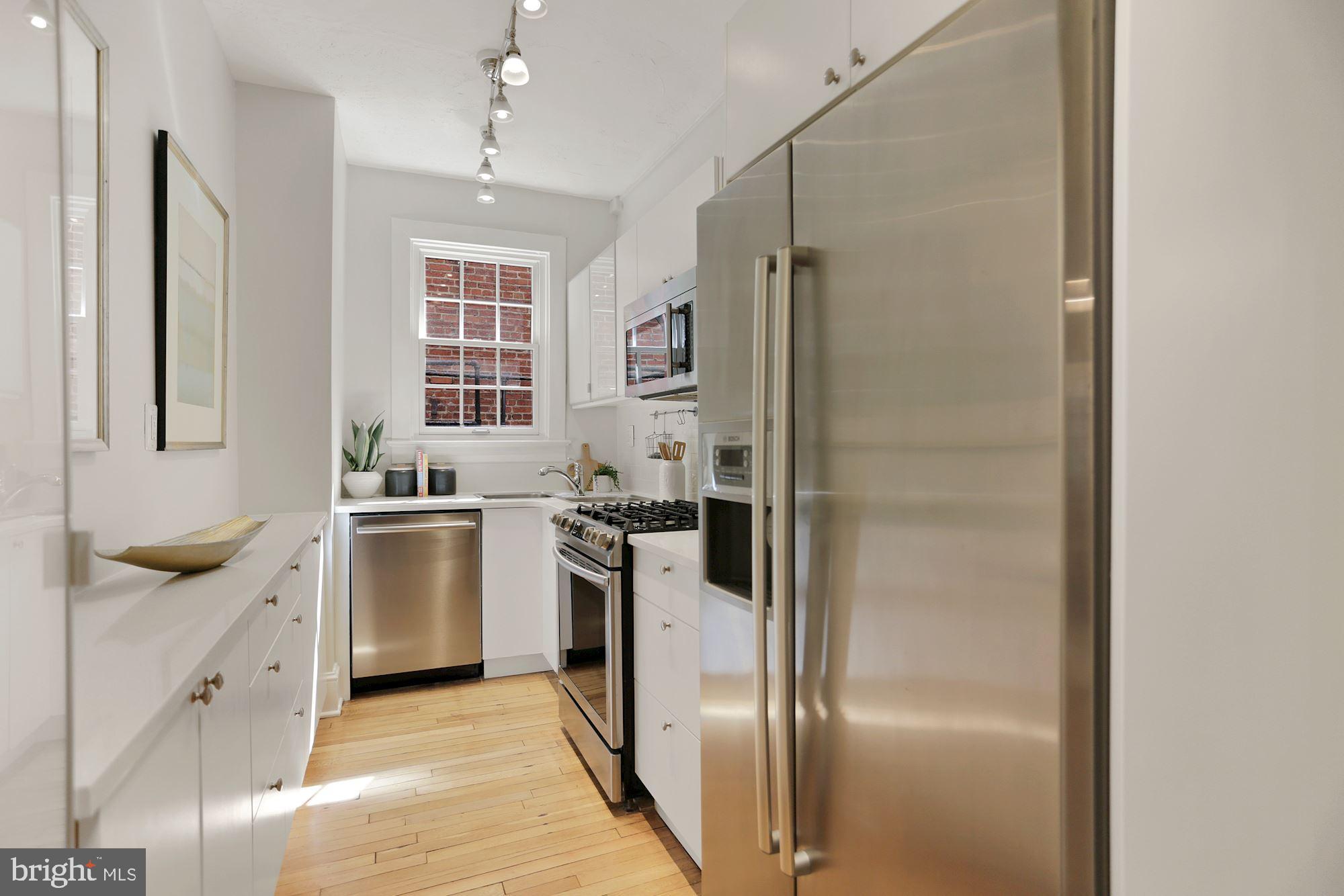 1705 Lanier Place Northwest, Unit 304 Washington, DC 20009 - Photo 11 of 35 Renovated Kitchen w SS Appliances & Quartz Counter