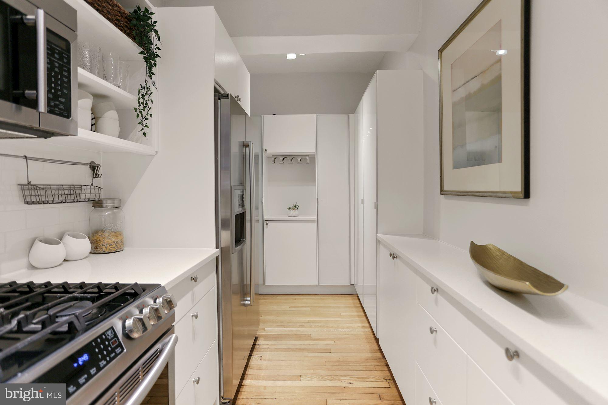 1705 Lanier Place Northwest, Unit 304 Washington, DC 20009 - Photo 12 of 35 A+ Kitchen Storage w Two Walls of Custom Built ins