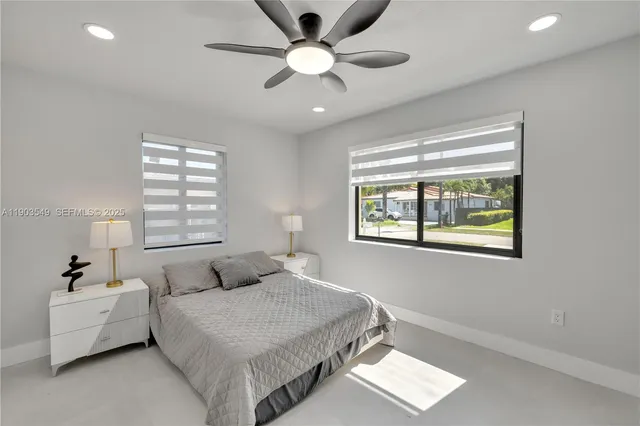 a bedroom with a large bed and a window