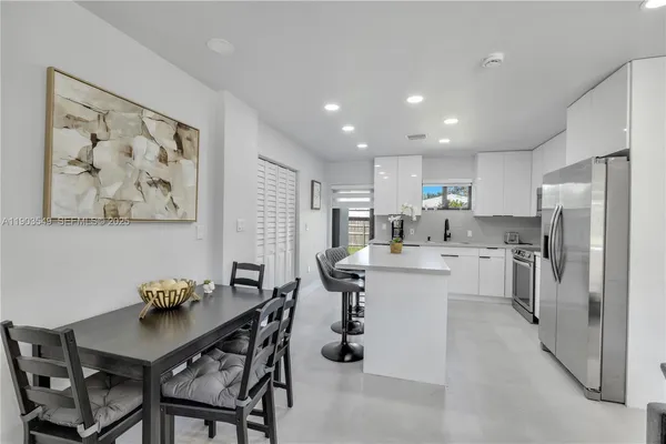 a kitchen with refrigerator and furniture