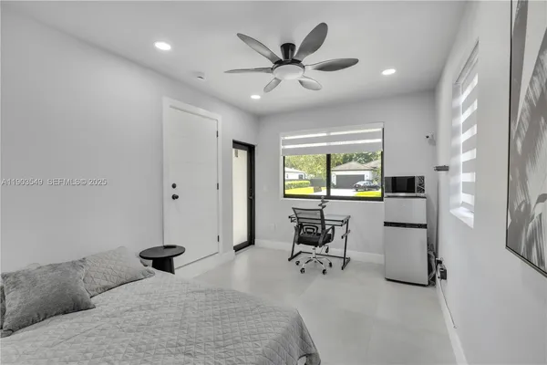 a bedroom with furniture and a window