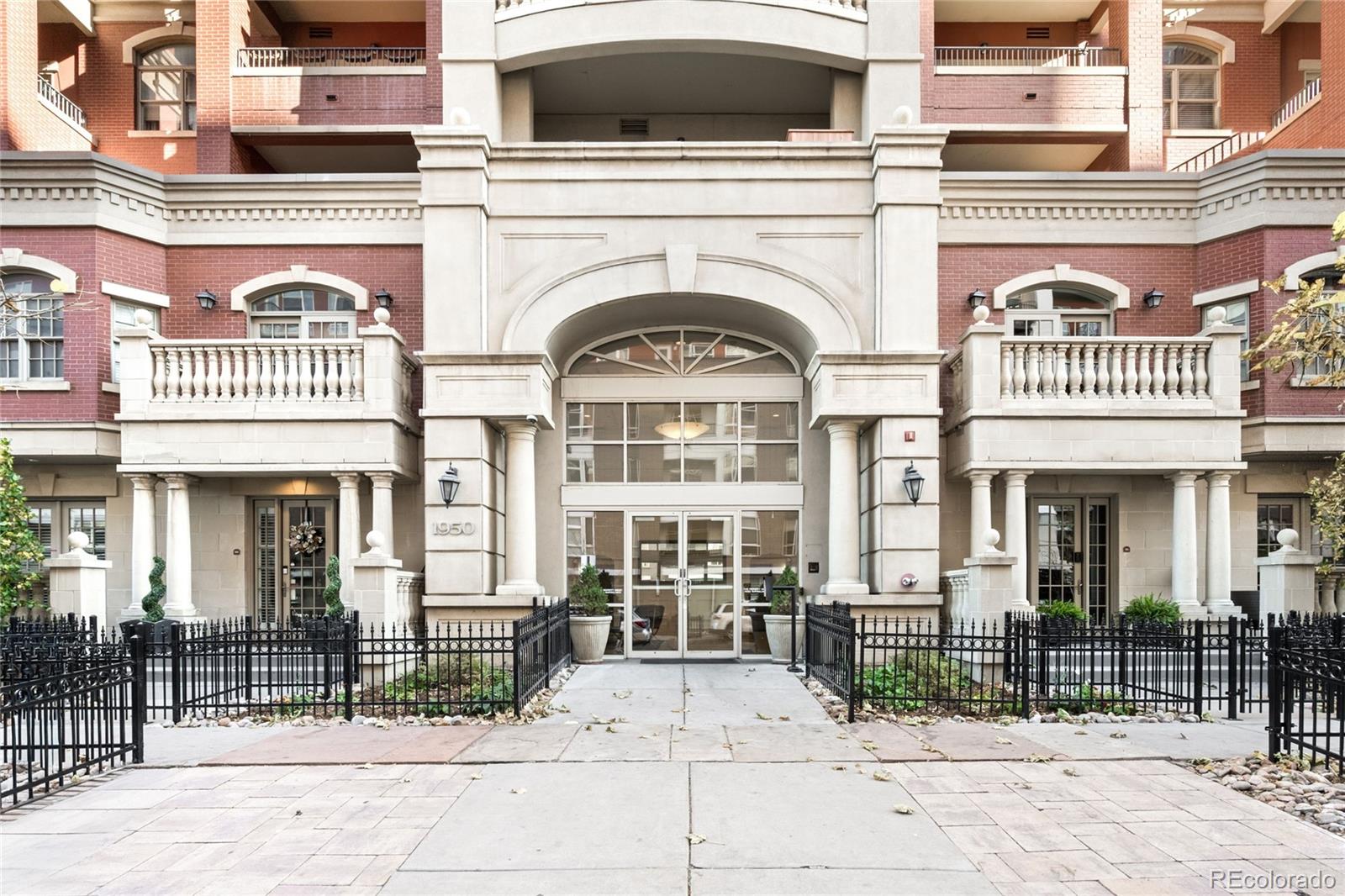 1950 Logan Street, Unit 901 Denver, CO 80203 - Photo 1 of 24 a view of a brick building with many windows