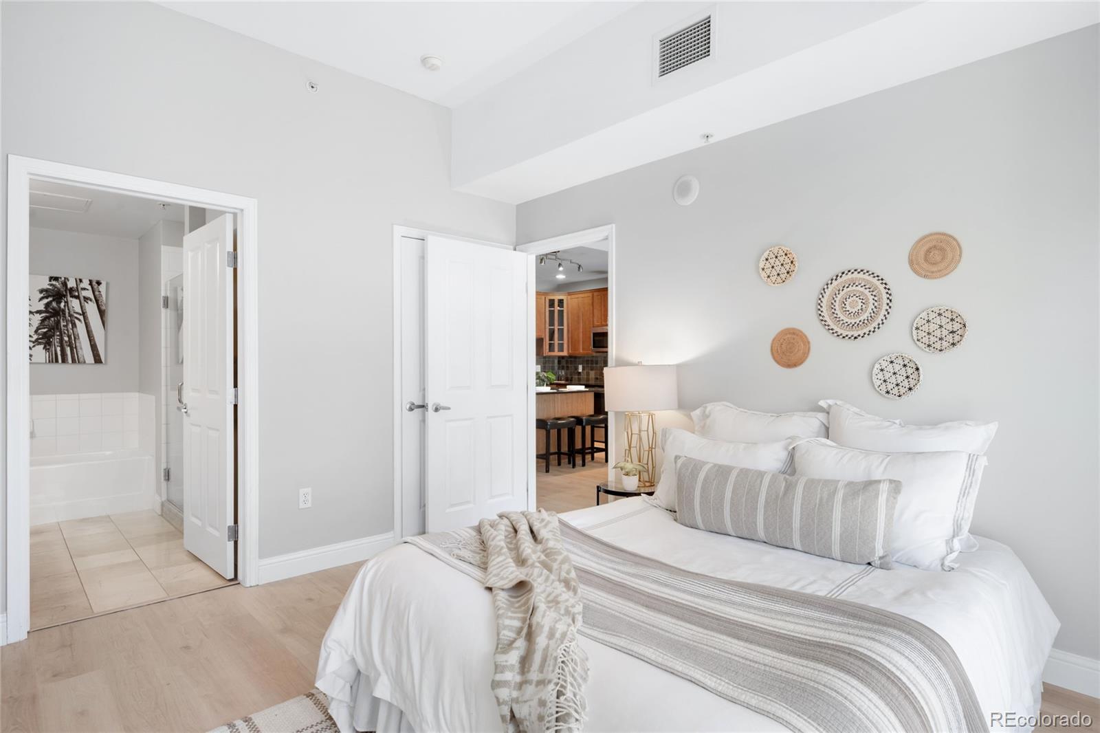 1950 Logan Street, Unit 901 Denver, CO 80203 - Photo 13 of 24 a bed room with a bed and a table