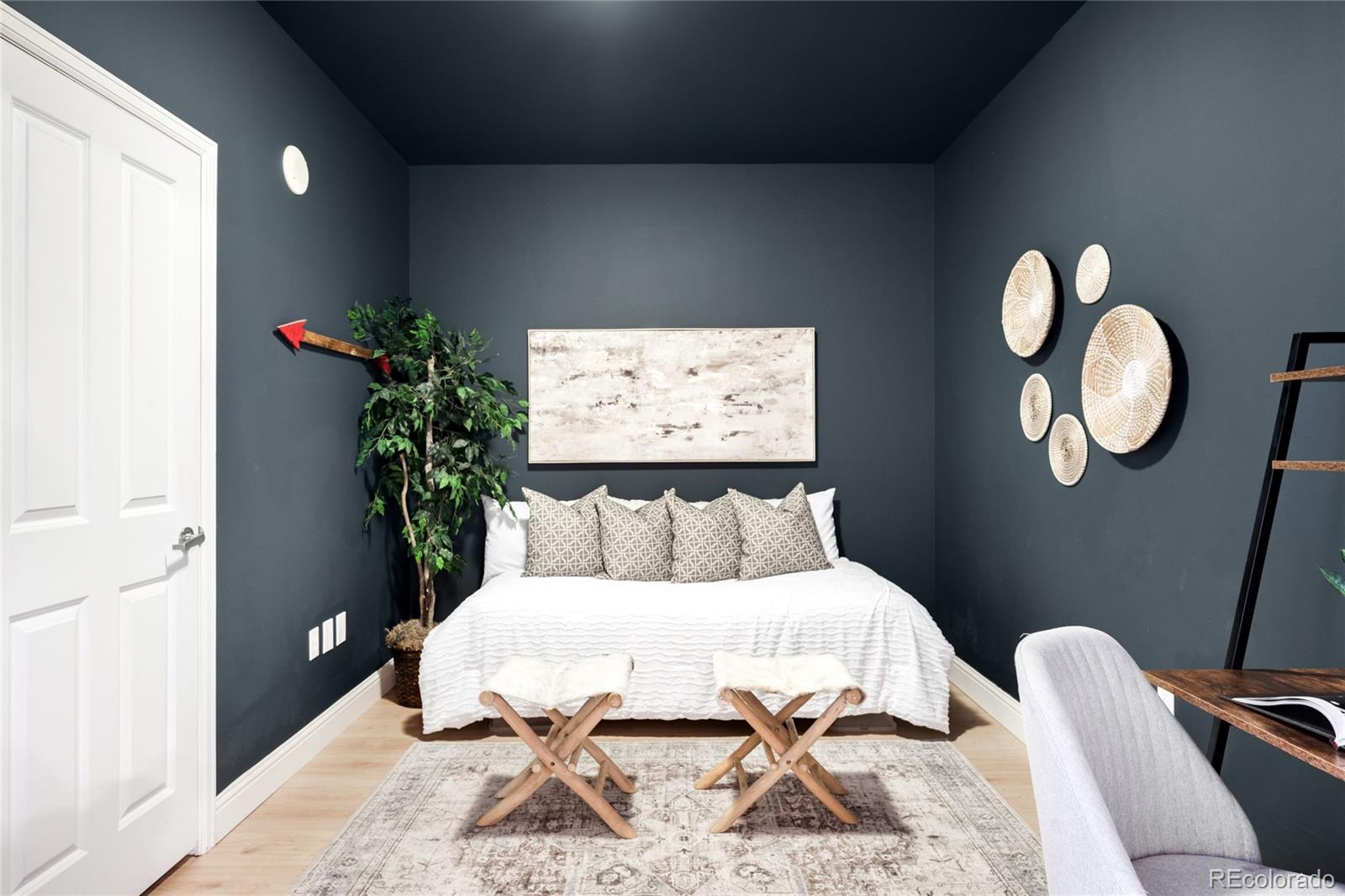 1950 Logan Street, Unit 901 Denver, CO 80203 - Photo 17 of 24 a bed sitting in a bedroom next to a window and a potted plant