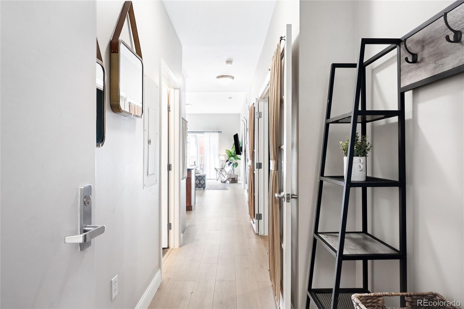 1950 Logan Street, Unit 901 Denver, CO 80203 - Photo 3 of 24 a view of a hallway with a glass door shower