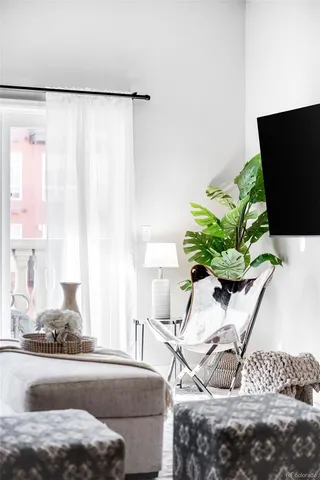 a view of living room with furniture and a potted plant