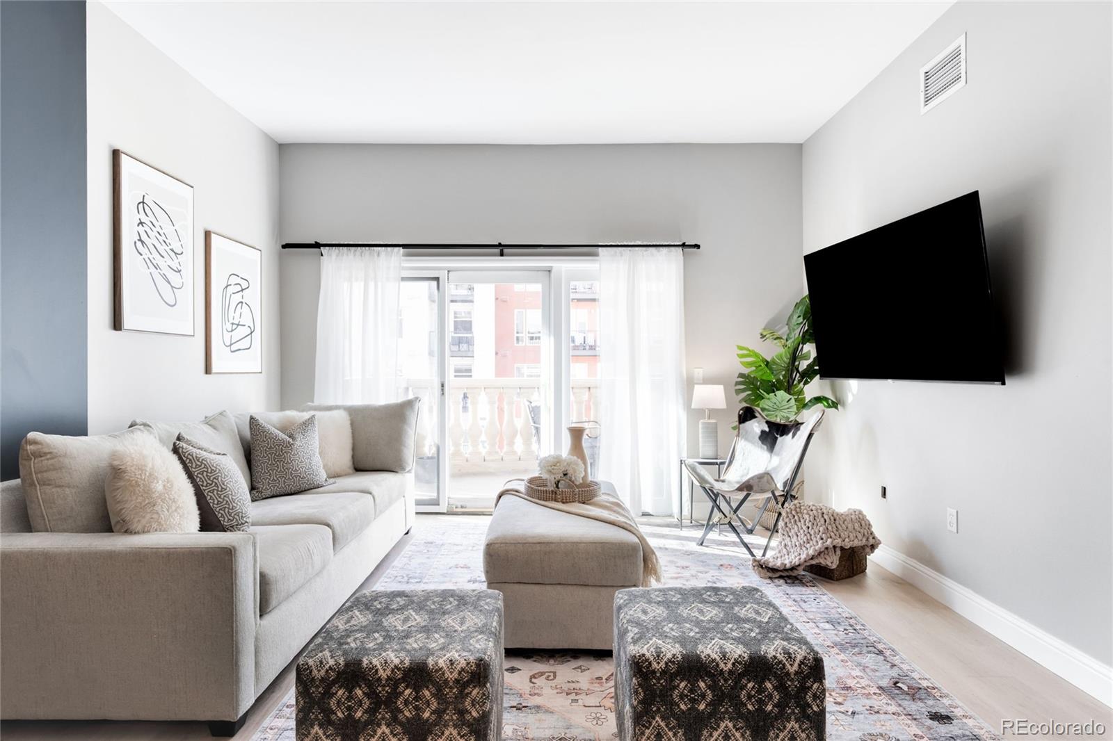 1950 Logan Street, Unit 901 Denver, CO 80203 - Photo 9 of 24 a living room with furniture and a flat screen tv