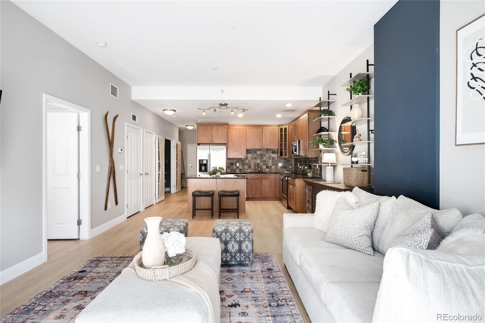 1950 Logan Street, Unit 901 Denver, CO 80203 - Photo 10 of 24 a living room with furniture and a wooden floor