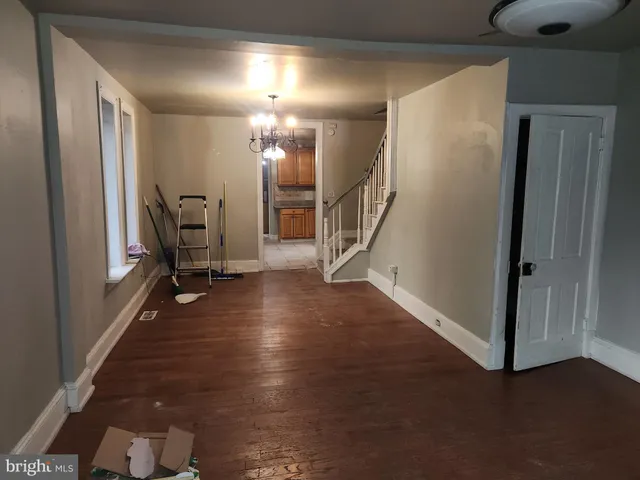 a view of a hallway with entryway and livingroom with furniture