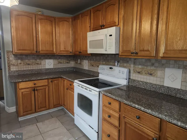 a kitchen with granite countertop cabinets stainless steel appliances and sink
