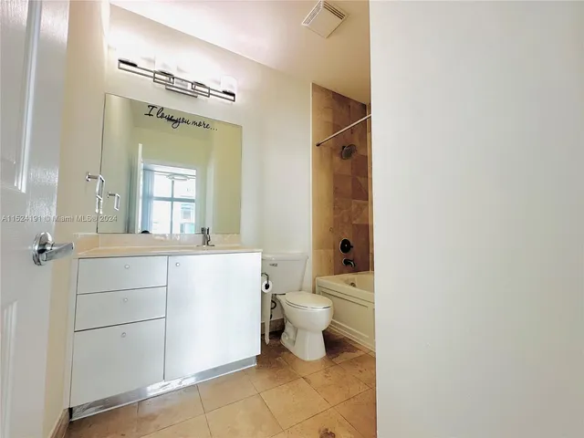a bathroom with a toilet and a bathtub