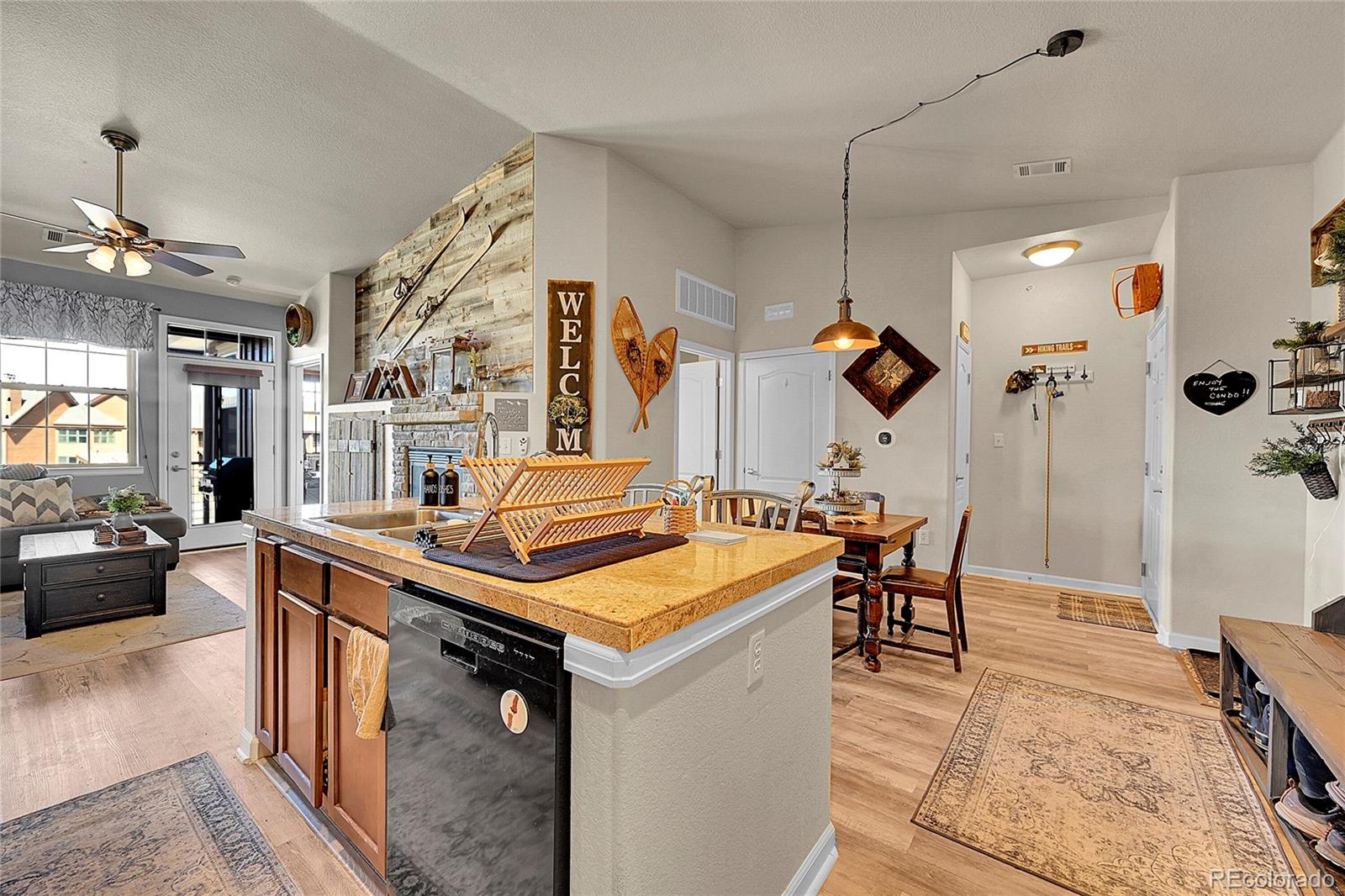 150 Village Road, Unit A302 Granby, CO 80446 - Photo 12 of 50 a kitchen with a stove a refrigerator and chairs