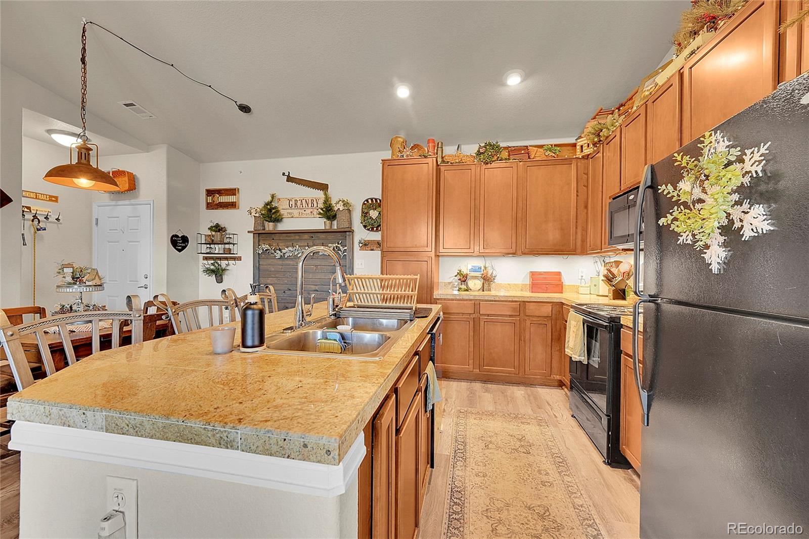 150 Village Road, Unit A302 Granby, CO 80446 - Photo 13 of 50 a kitchen with stainless steel appliances granite countertop a sink refrigerator and cabinets