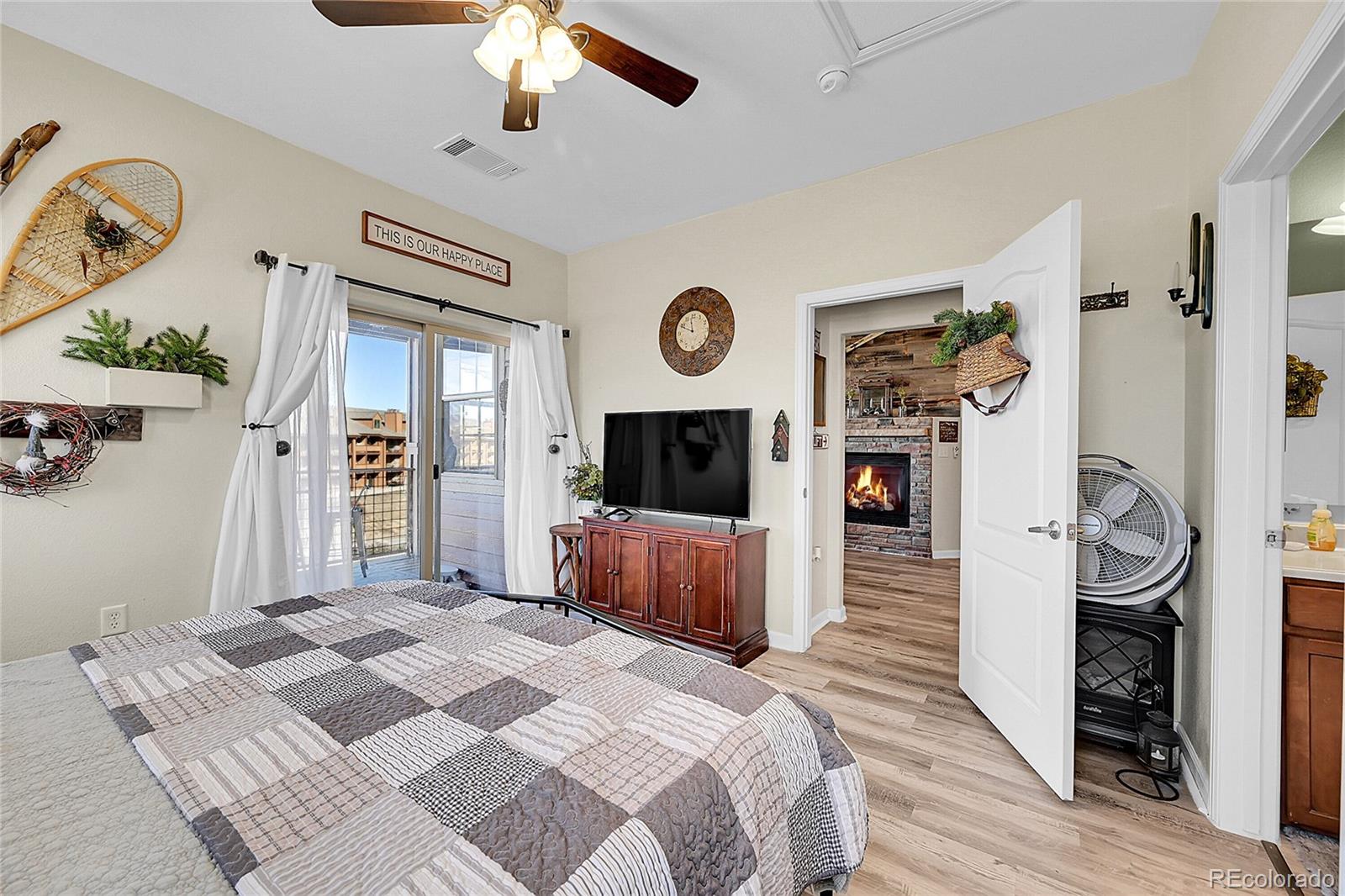 150 Village Road, Unit A302 Granby, CO 80446 - Photo 21 of 50 a bedroom with furniture and a flat screen tv