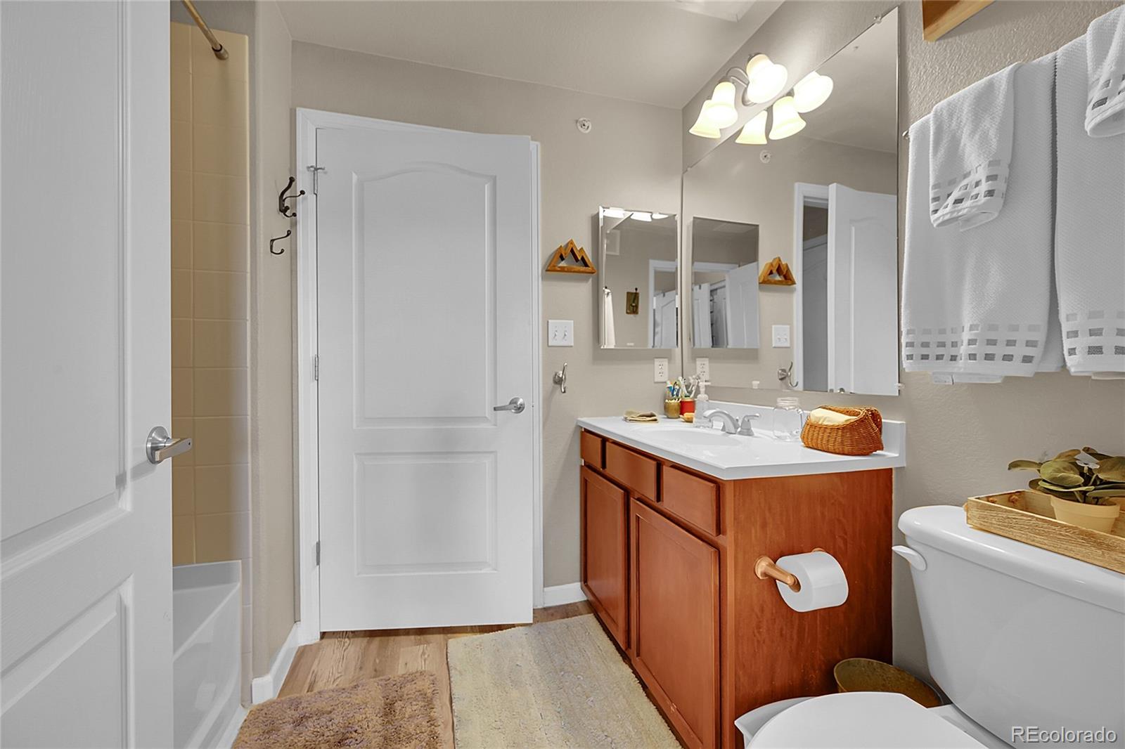 150 Village Road, Unit A302 Granby, CO 80446 - Photo 36 of 50 a bathroom with a sink a mirror and a toilet