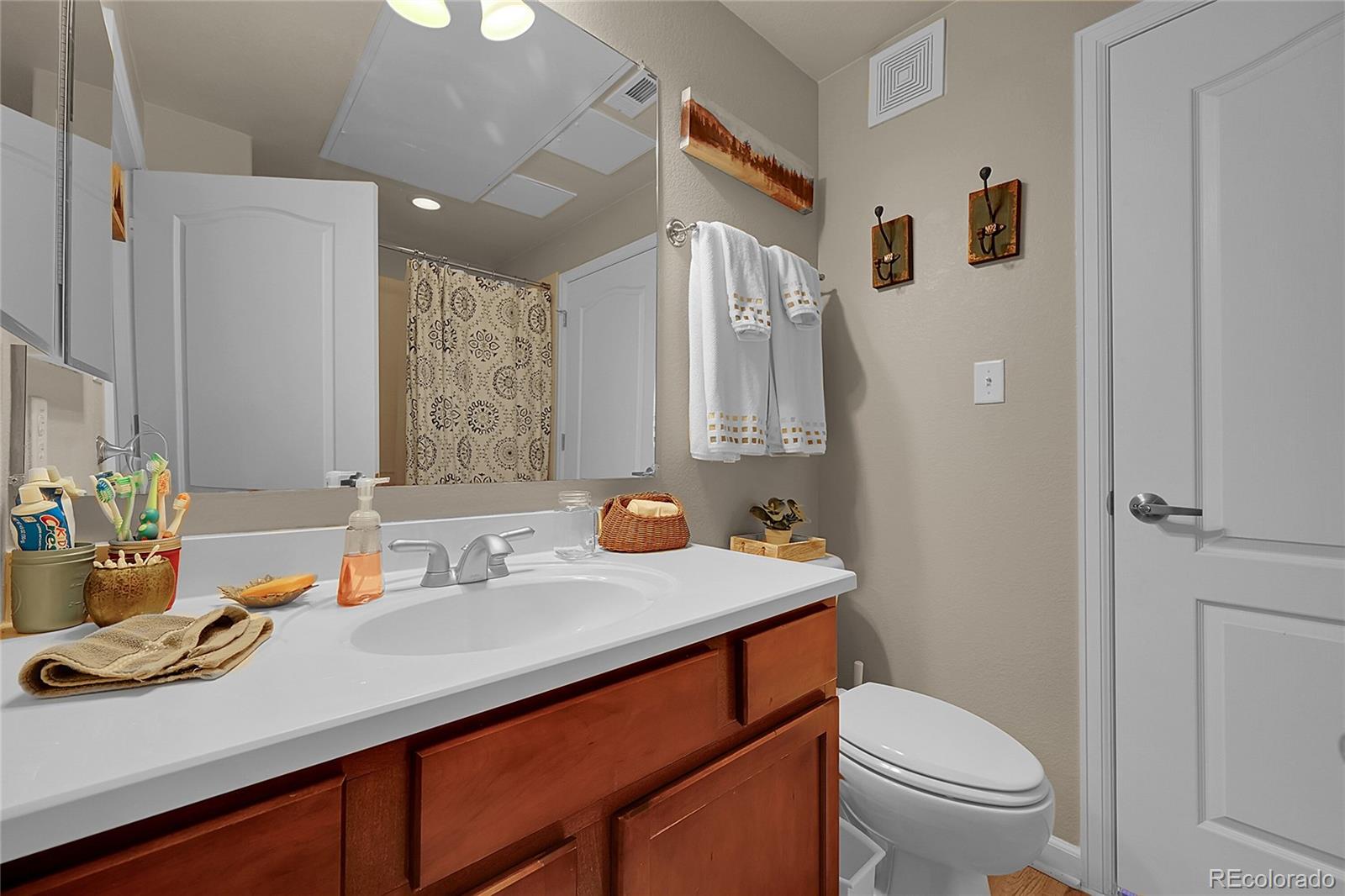 150 Village Road, Unit A302 Granby, CO 80446 - Photo 38 of 50 a bathroom with a sink toilet vanity and shower