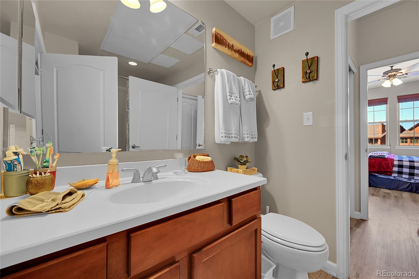 150 Village Road, Unit A302 Granby, CO 80446 - Photo 39 of 50 a bathroom with a sink toilet vanity and shower