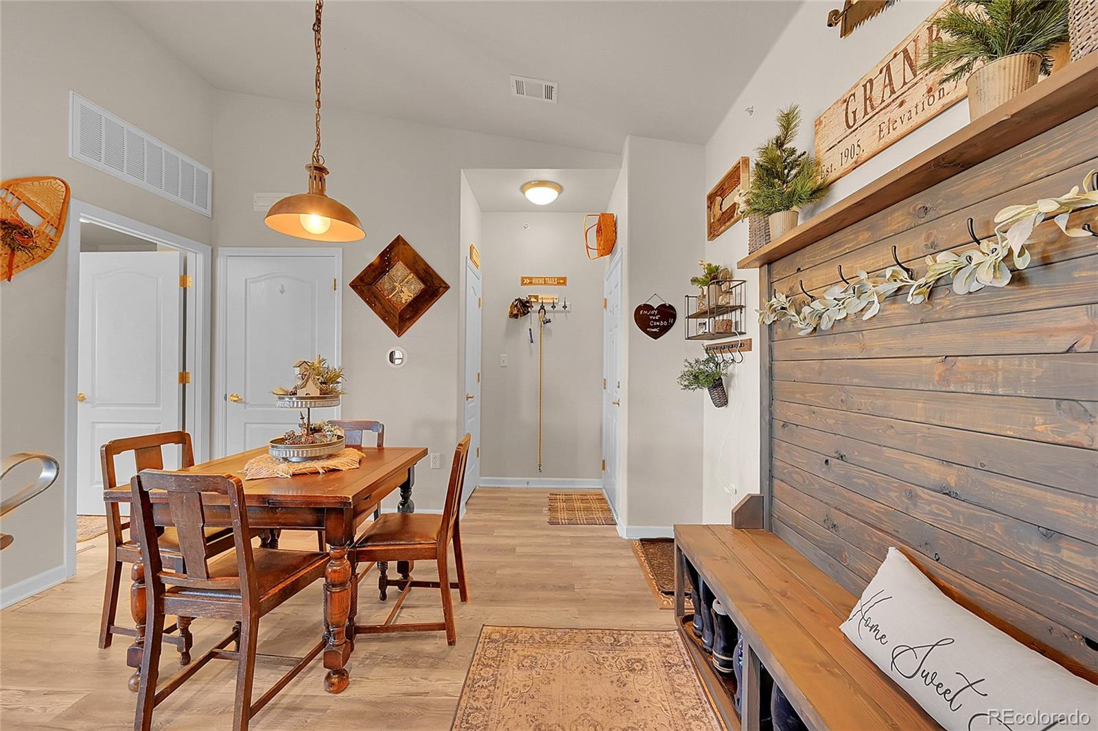 150 Village Road, Unit A302 Granby, CO 80446 - Photo 5 of 50 a view of a dining room with furniture and wooden floor