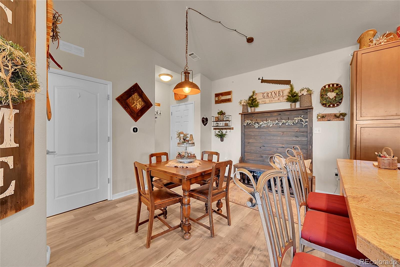150 Village Road, Unit A302 Granby, CO 80446 - Photo 7 of 50 a view of a dining room with furniture and wooden floor
