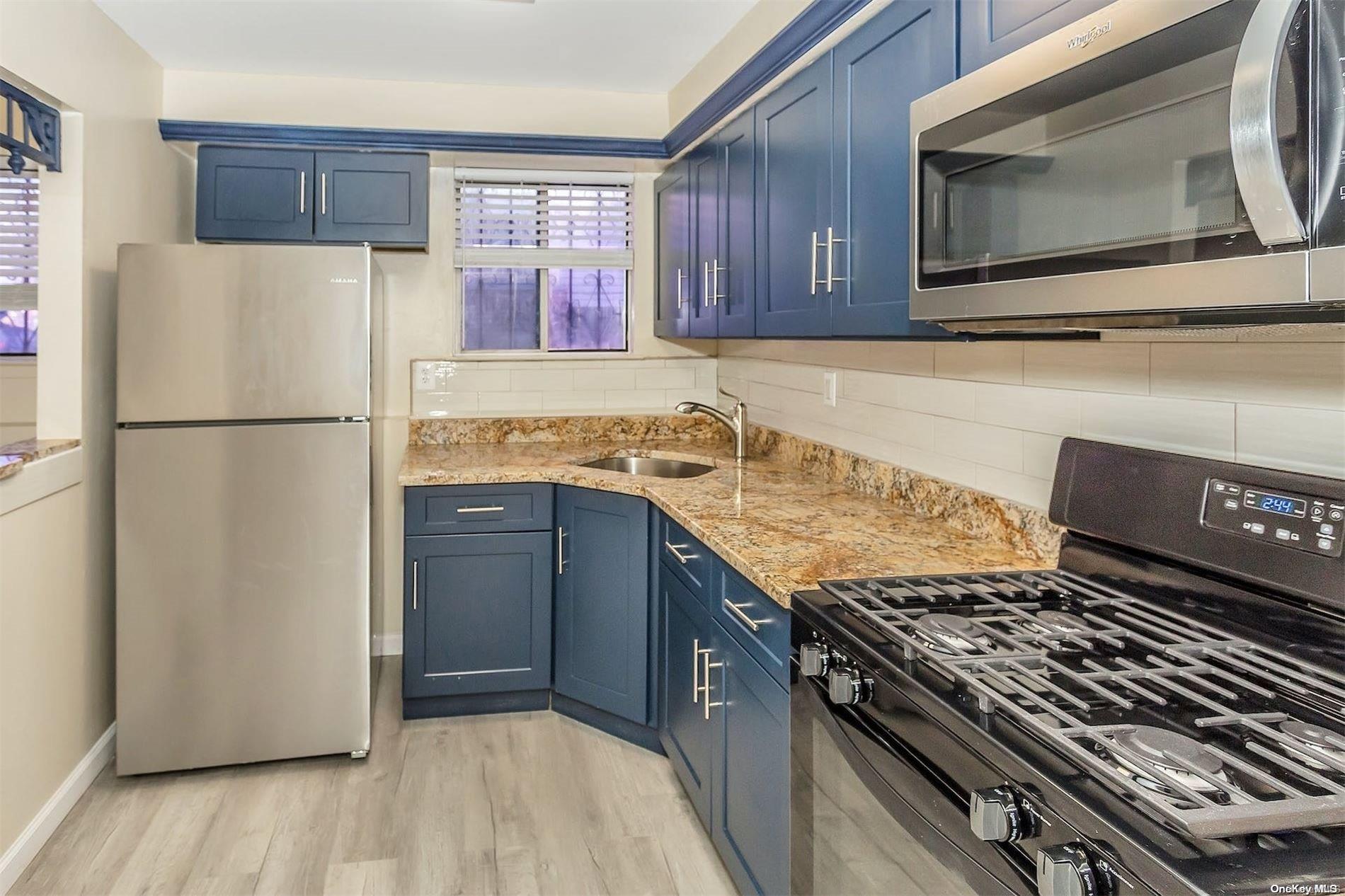 a kitchen with a stove microwave and refrigerator