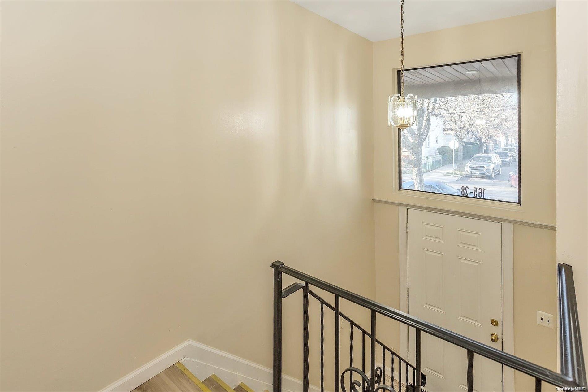 165-28 144th Drive Queens, NY 11434 - Photo 13 of 25 a view of a small space with wooden floor and a window