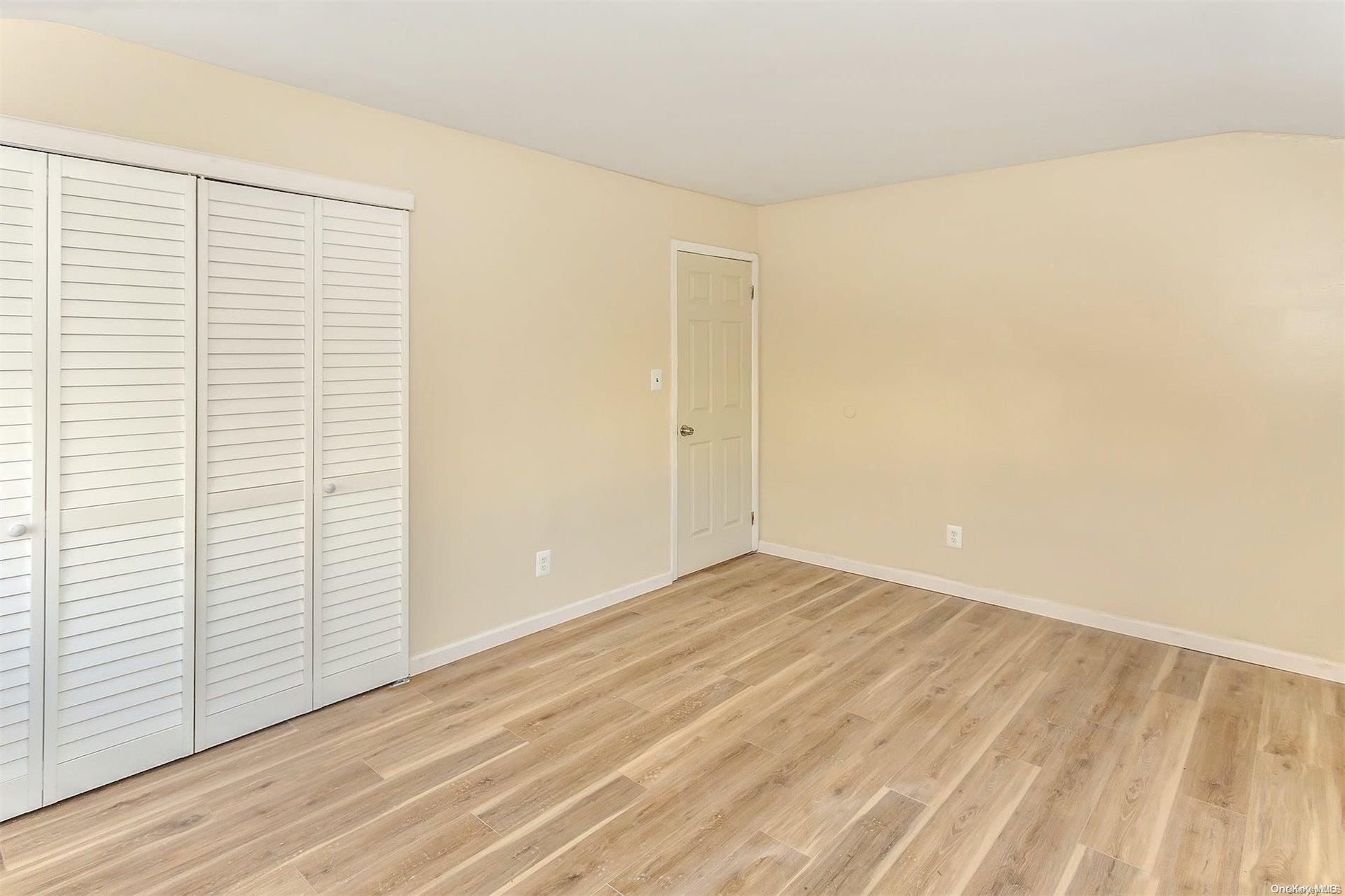 165-28 144th Drive Queens, NY 11434 - Photo 16 of 25 an empty room with wooden floor