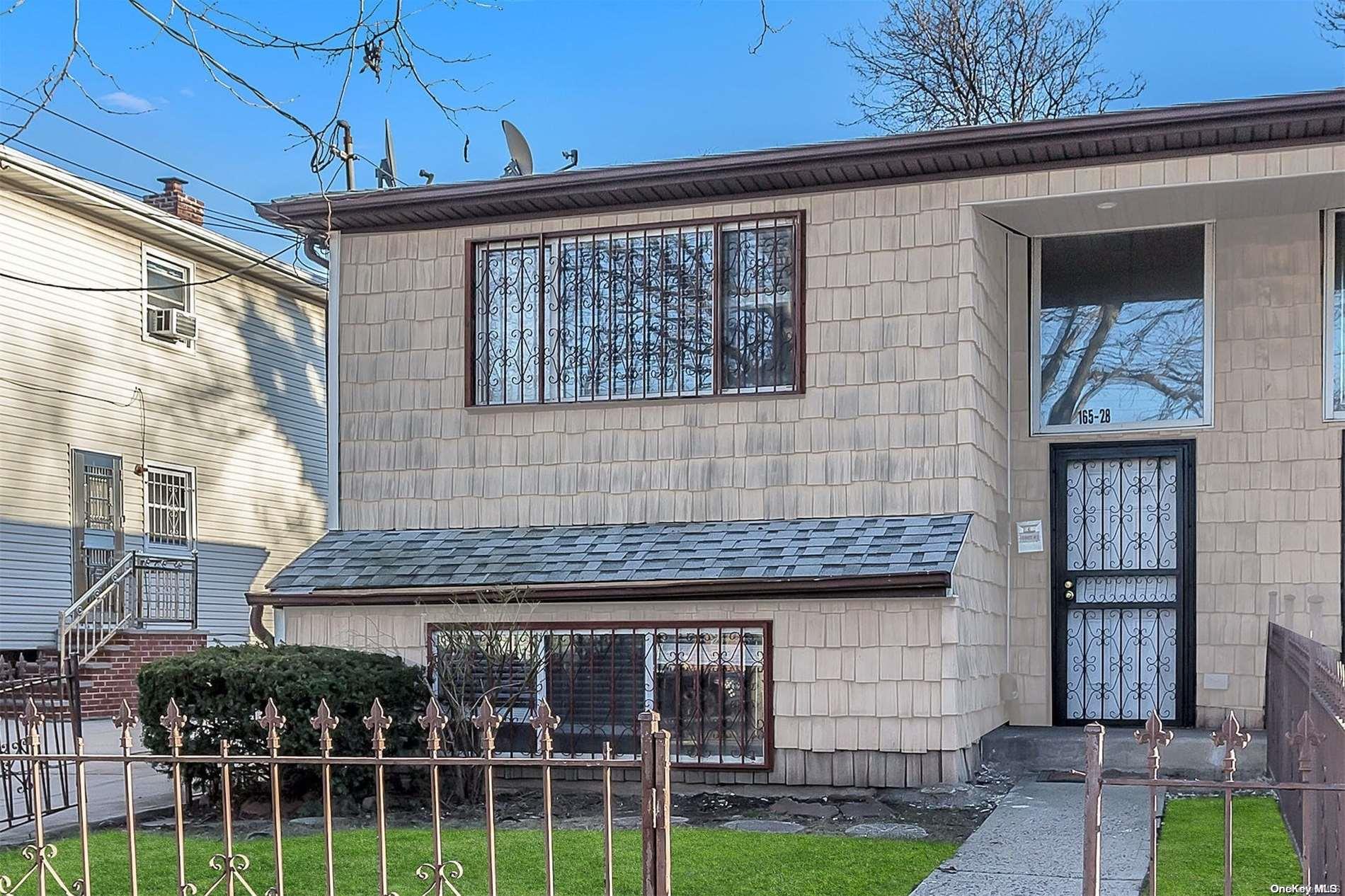 165-28 144th Drive Queens, NY 11434 - Photo 2 of 25 a front view of a house with a garden