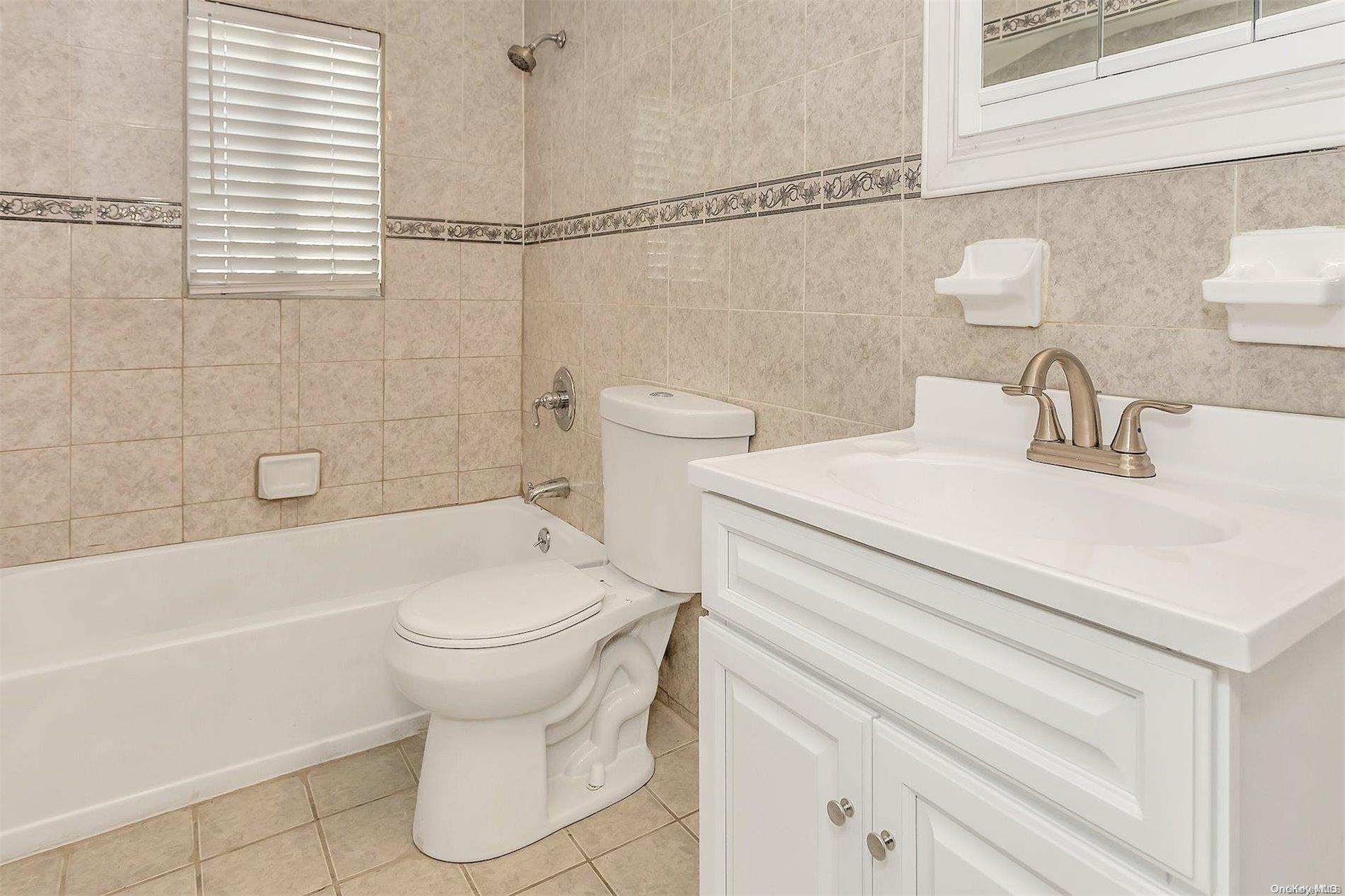 165-28 144th Drive Queens, NY 11434 - Photo 21 of 25 a bathroom with a sink a toilet and bathtub