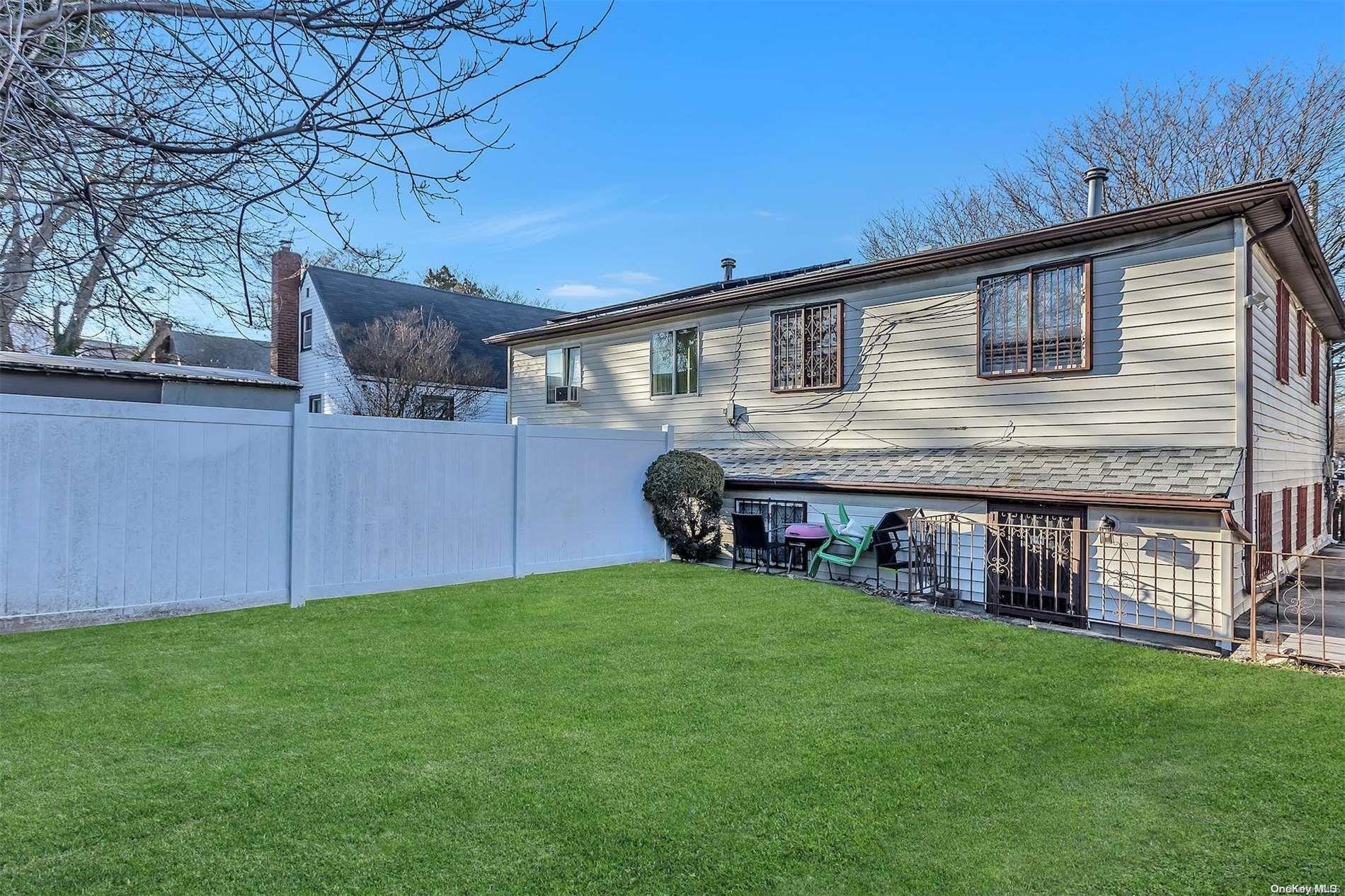 165-28 144th Drive Queens, NY 11434 - Photo 22 of 25 a front view of a house with garden