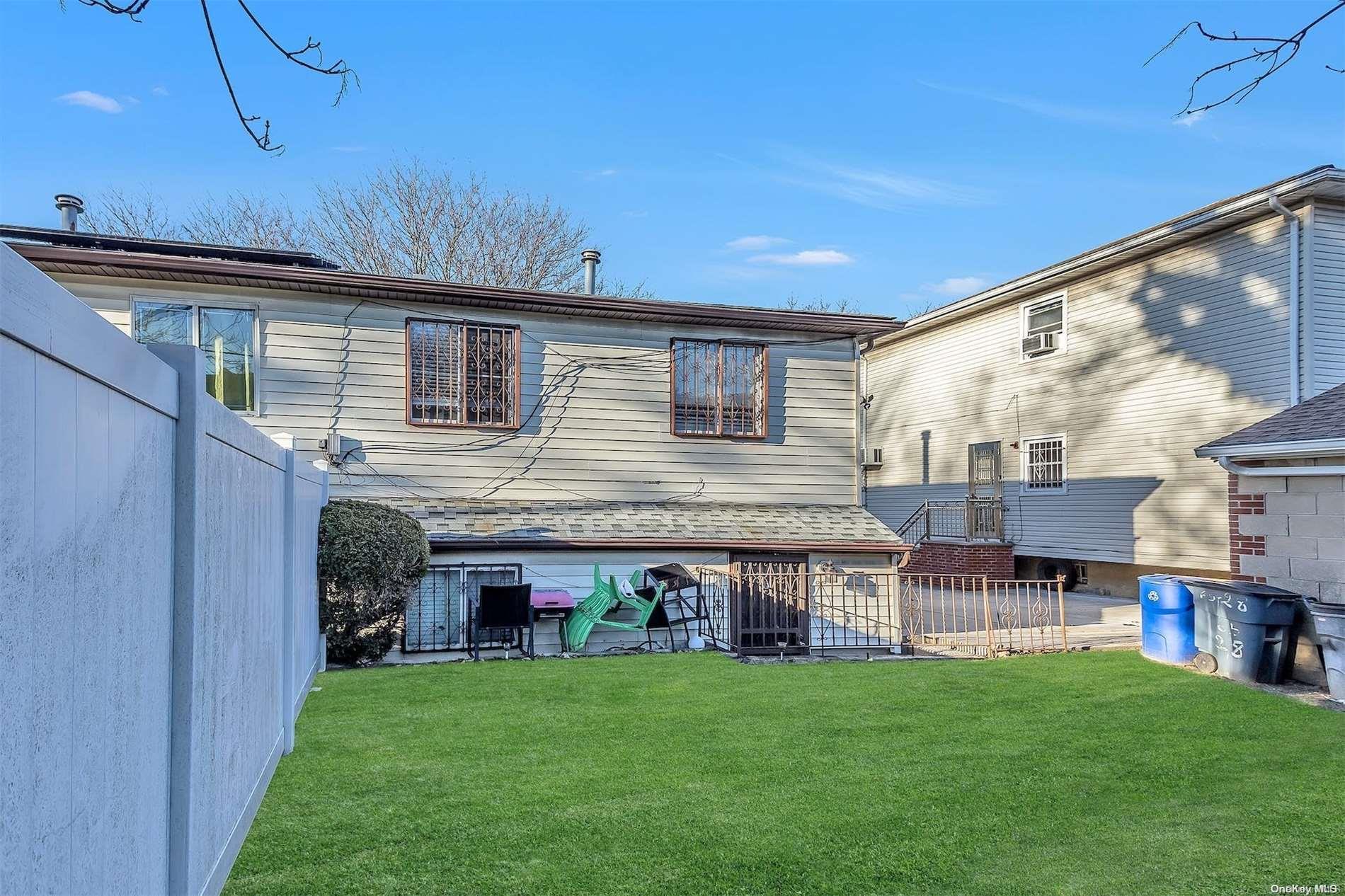 165-28 144th Drive Queens, NY 11434 - Photo 23 of 25 a backyard of a house with table and chairs