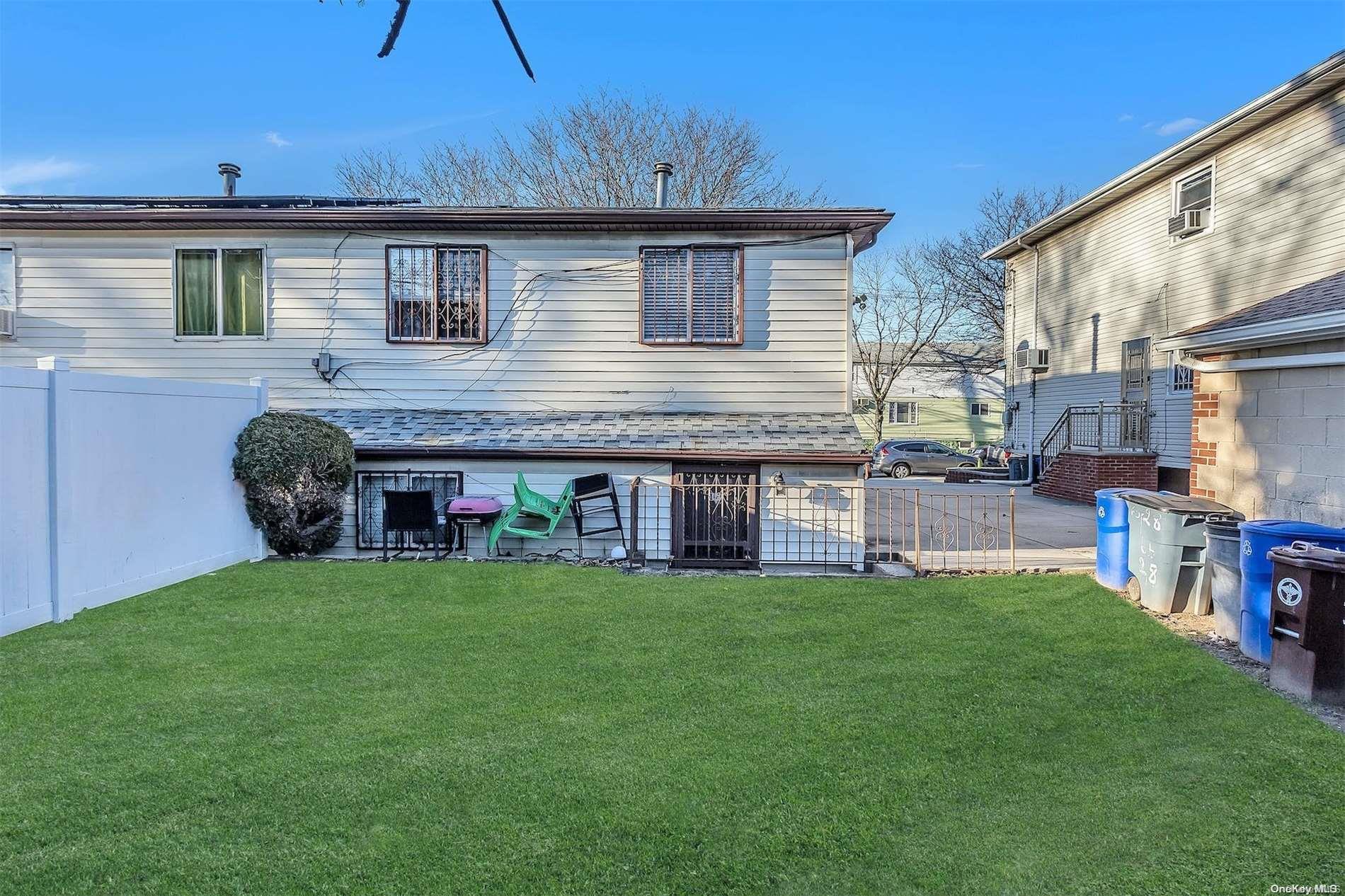 165-28 144th Drive Queens, NY 11434 - Photo 24 of 25 a view of a house with a yard and sitting area
