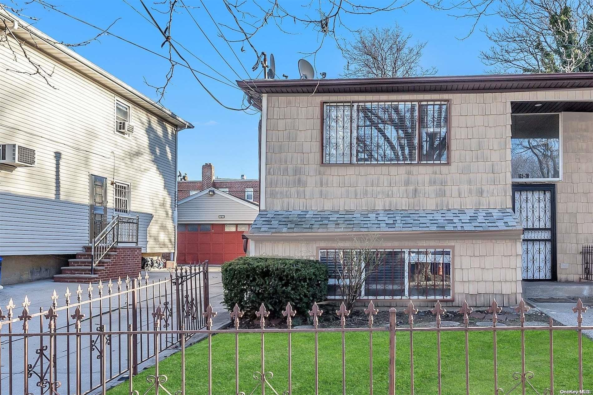 165-28 144th Drive Queens, NY 11434 - Photo 4 of 25 a front view of a house with garden
